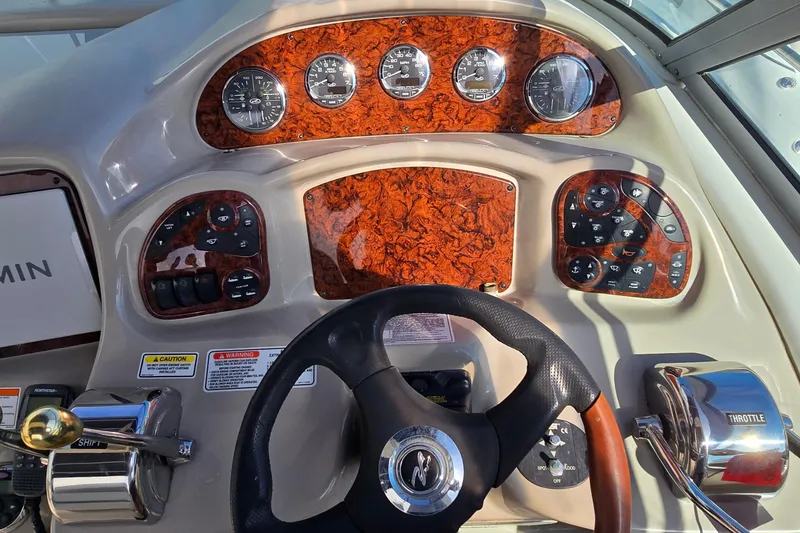 Slide: The Image of Helm of 2007 Sea Ray 340 Sundancer with woodgrain dash and modern controls. - 7