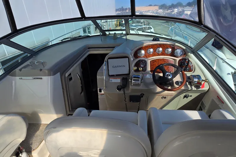 Slide: The Image of 2007 Sea Ray 340 Sundancer helm with Garmin navigation, wood accents, and dual seating. - 8