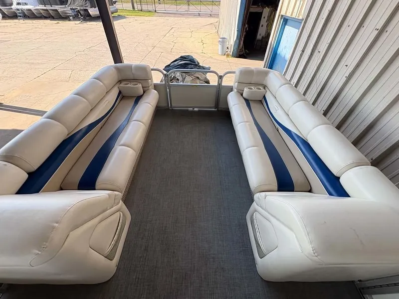 Slide: The Image of The image shows the interior of a 2002 Bennington 2250 LX with white and blue seating. - 3