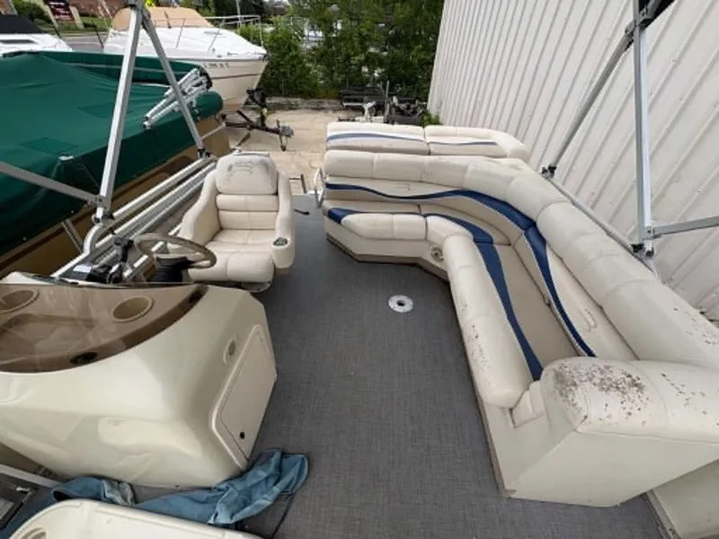Slide: The Image of Interior of a Bennington 2275 pontoon boat with beige seating and blue accents. - 5