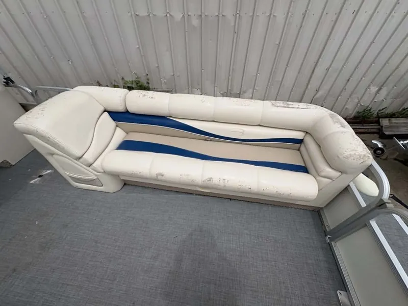 Slide: The Image of A white and blue seating sofa on a boat with gray flooring. - 4