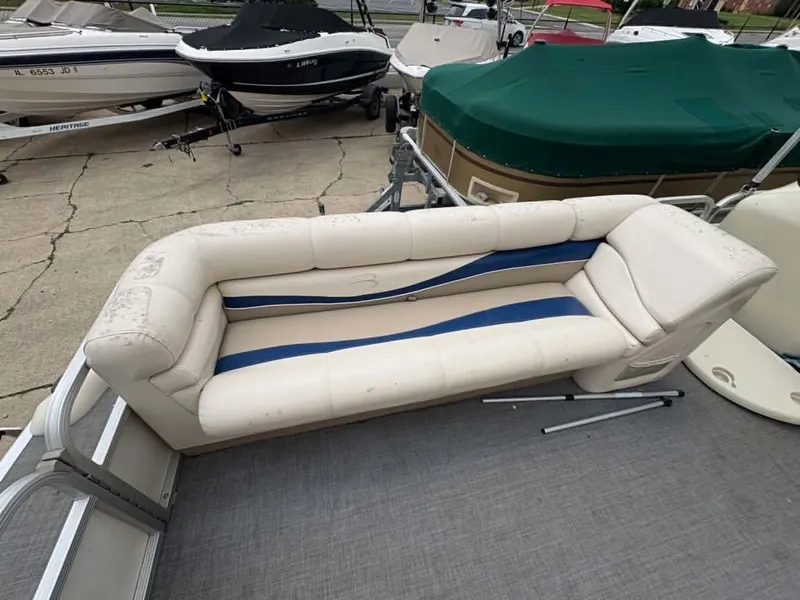 Slide: The Image of A white and blue seating sofa on a boat dock, surrounded by several boats. - 3