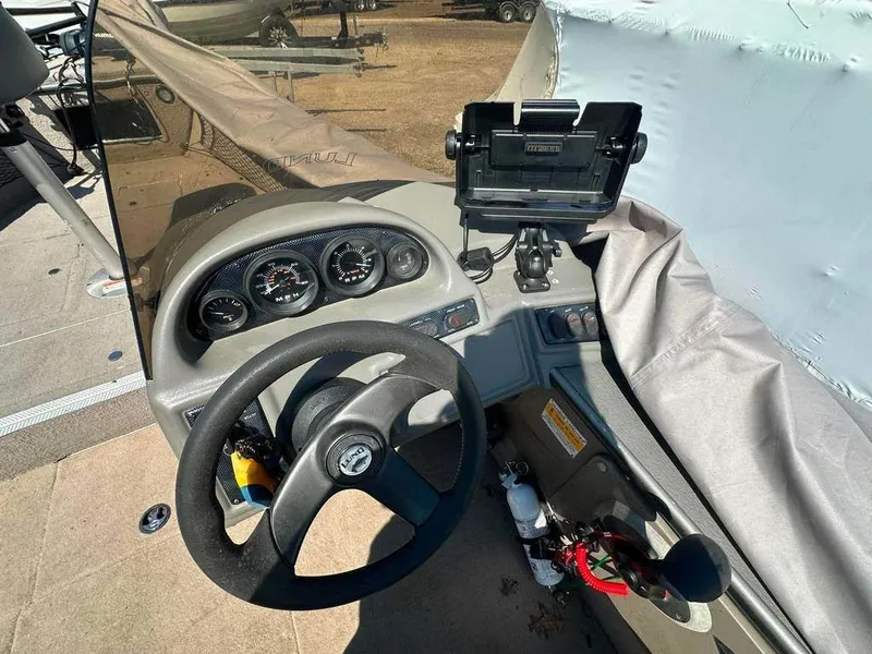 Slide: The Image of The image shows the cockpit of a 2004 Lund 18 MR PIKE boat with steering wheel and gauges. - 8