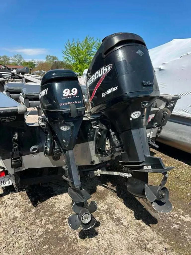Slide: The Image of Two outboard motors on a boat, including a Mercury 9.9 ProKicker and a Mercury OptiMax. - 12