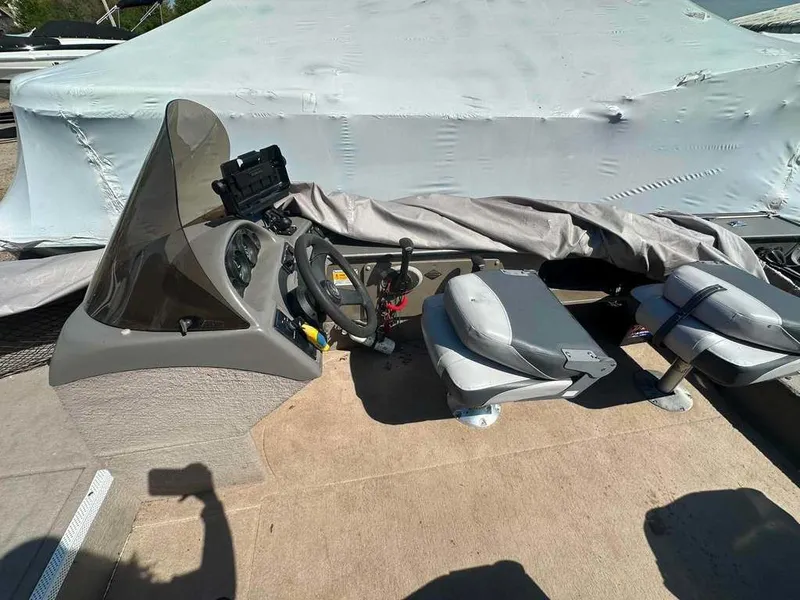 Slide: The Image of The image shows the cockpit of a 2004 Lund 18 MR PIKE boat with steering and seats. - 7