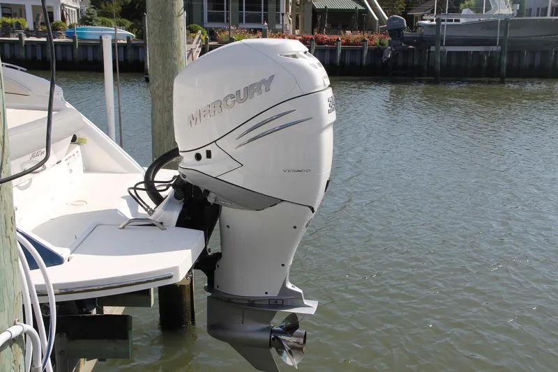 Slide: The Image of 2021 Cobalt 25SC boat with Mercury Verado outboard motor docked by the water. - 12