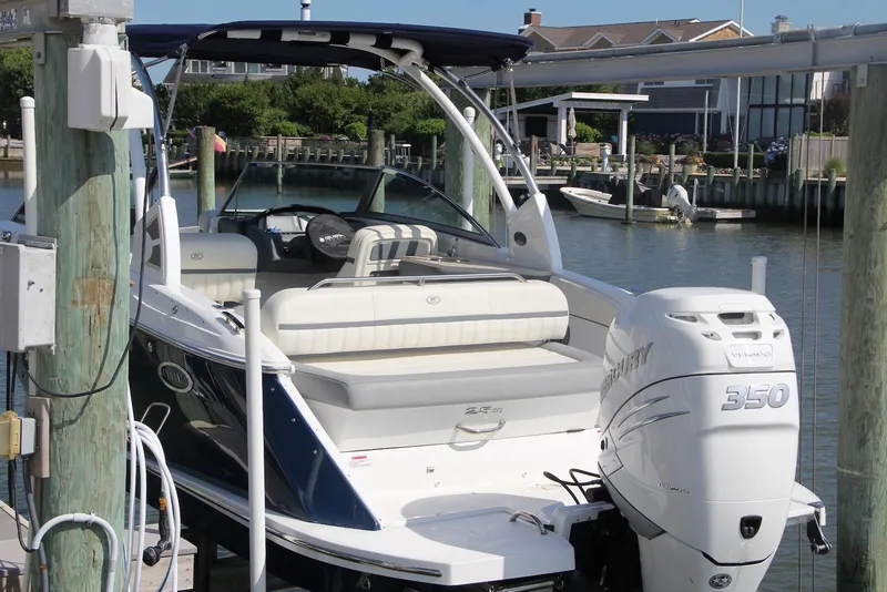 Slide: The Image of 2021 Cobalt 25SC boat docked with Mercury 350 outboard engine, in a marina setting. - 11