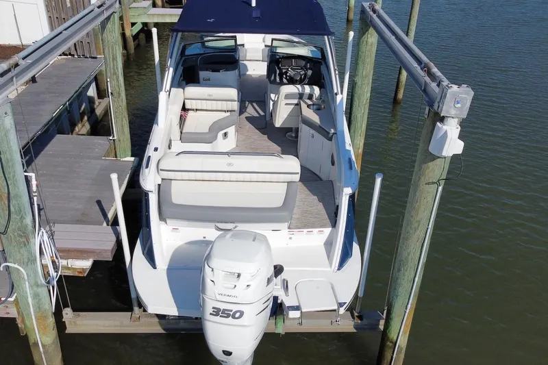 Slide: The Image of 2021 Cobalt 25SC boat docked, featuring spacious seating and a powerful 350 Verado engine. - 10