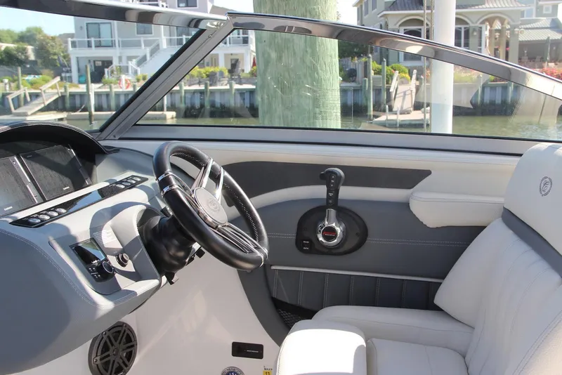 Slide: The Image of 2021 Cobalt 25SC boat interior with steering wheel and control panel. - 4