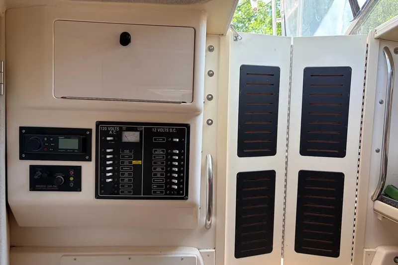 Slide: The Image of 1999 Grady-White Marlin 300 electrical panel with AC and DC controls. - 8