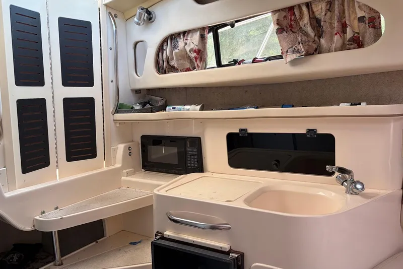 Slide: The Image of Interior of 1999 Grady-White Marlin 300 boat with kitchenette and microwave. - 7