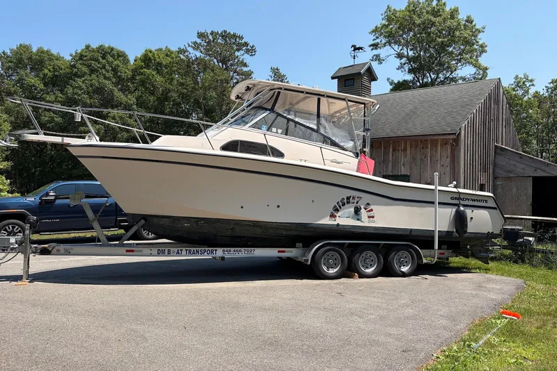 The Image of 1999 Grady-White Marlin 300 boat on trailer near rustic barn. - 0