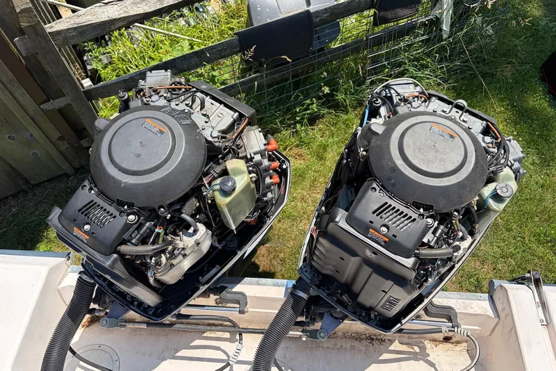 Slide: The Image of Twin outboard engines on a 1999 Grady-White Marlin 300 boat, viewed from above. - 16
