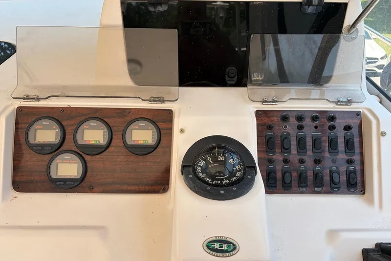 Slide: The Image of Dashboard of a 1999 Grady-White Marlin 300 boat with gauges and switches. - 12