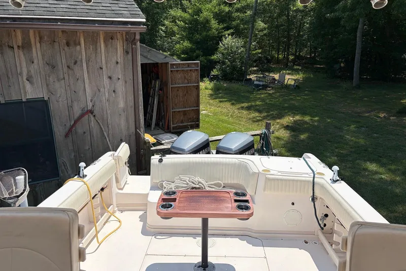 Slide: The Image of 1999 Grady-White Marlin 300 boat interior with twin Yamaha engines, docked near wooden shed. - 4