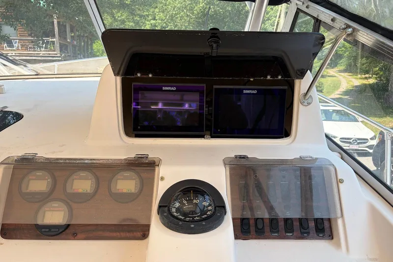 Slide: The Image of 1999 Grady-White Marlin 300 boat dashboard with Simrad displays and Yamaha gauges. - 11