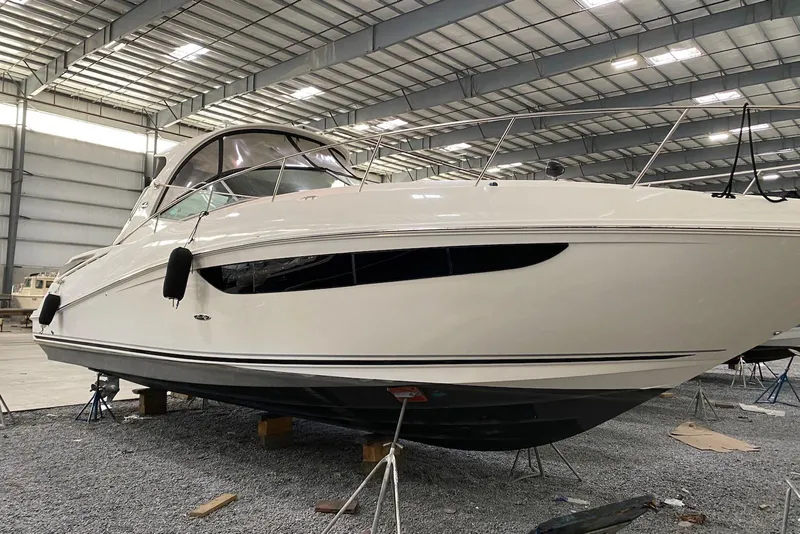 The Image of 2016 Sea Ray Sundancer 370 yacht in a spacious indoor storage facility. - 0