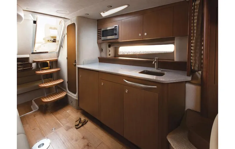Slide: The Image of Manufacturer Provided Image: Interior of 2016 Sea Ray 370 Sundancer yacht with modern kitchen and wooden cabinetry. - 3