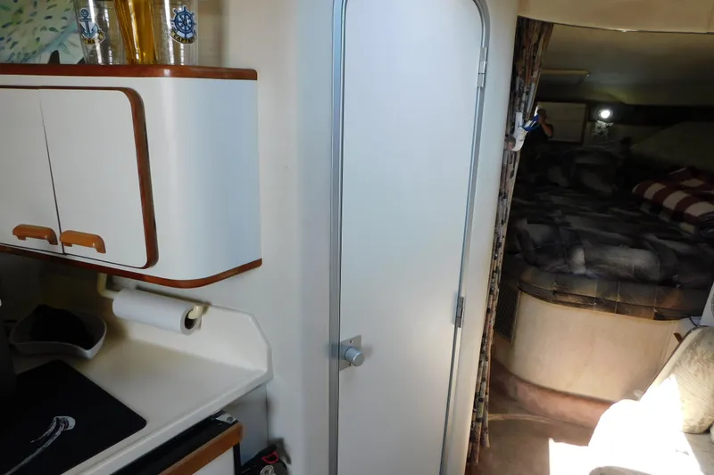 Slide: The Image of Interior of 1990 Sea Ray 350 Express Cruiser with kitchenette and cozy sleeping area. - 41