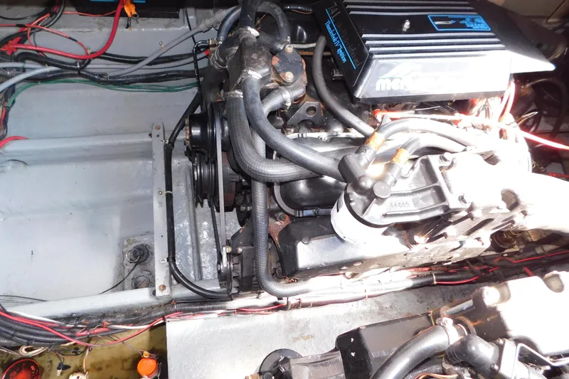 Slide: The Image of Engine compartment of a 1990 Sea Ray 350 Express Cruiser with visible wiring and components. - 65