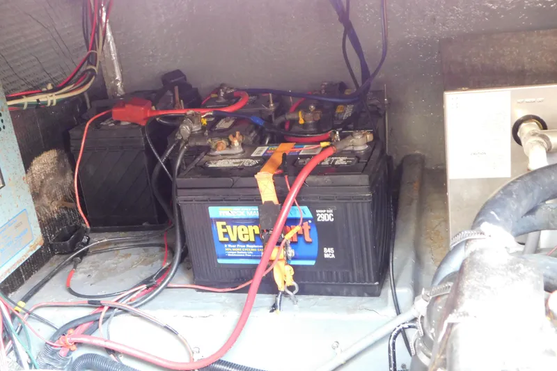 Slide: The Image of Battery compartment of a 1990 Sea Ray 350 Express Cruiser with EverStart batteries. - 71