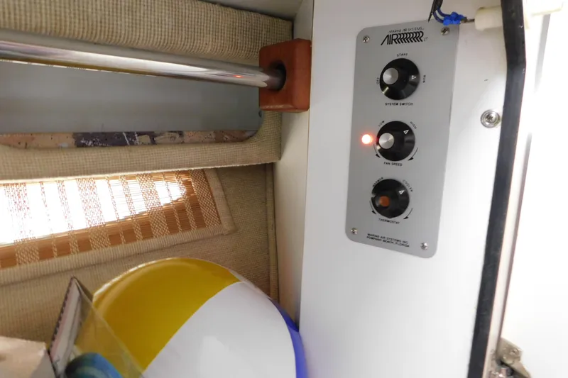 Slide: The Image of Control panel inside 1990 Sea Ray 350 Express Cruiser with beach ball and window blinds. - 35