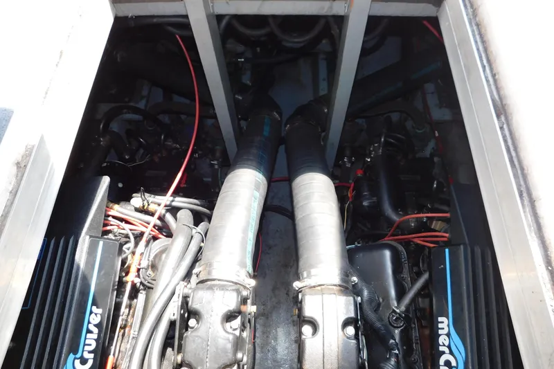 Slide: The Image of Engine compartment of a 1990 Sea Ray 350 Express Cruiser, featuring dual MerCruiser engines. - 67