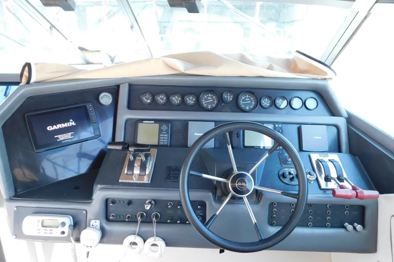 Slide: The Image of 1990 Sea Ray 350 Express Cruiser helm with Garmin navigation and control panel. - 13