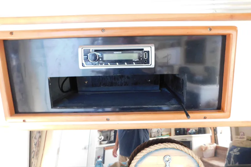 Slide: The Image of 1990 Sea Ray 350 Express Cruiser stereo system with Kenwood receiver in wooden frame. - 63