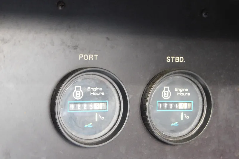Slide: The Image of Engine hour meters on 1990 Sea Ray 350 Express Cruiser dashboard, showing port and starboard readings. - 72