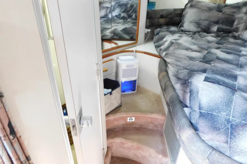 Slide: The Image of Interior cabin of 1990 Sea Ray 350 Express Cruiser with bed and dehumidifier. - 32