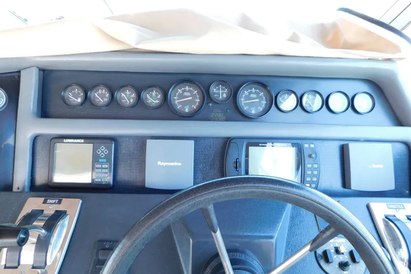Slide: The Image of 1990 Sea Ray 350 Express Cruiser dashboard with gauges and navigation equipment. - 17