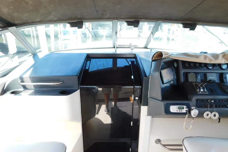 Slide: The Image of 1990 Sea Ray 350 Express Cruiser cockpit with navigation controls and seating area. - 22
