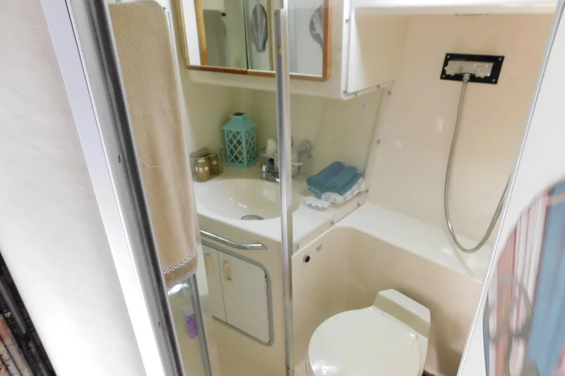 Slide: The Image of Bathroom interior of 1990 Sea Ray 350 Express Cruiser with shower and sink. - 39