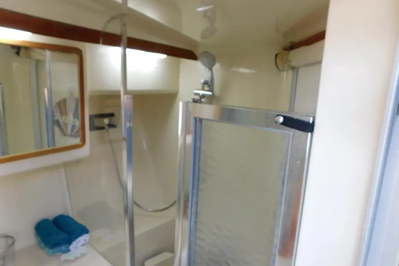 Slide: The Image of Bathroom interior of 1990 Sea Ray 350 Express Cruiser with shower and mirror. - 43