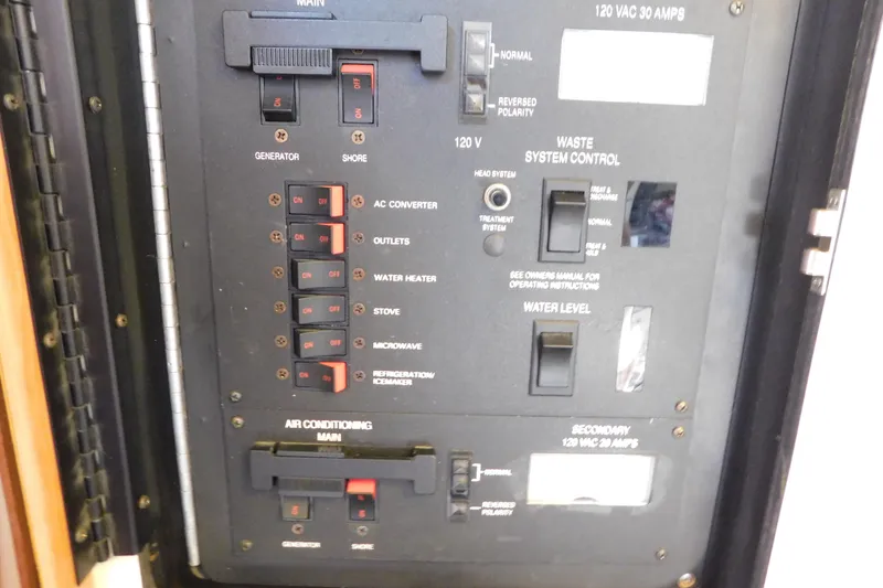 Slide: The Image of Electrical control panel of a 1990 Sea Ray 350 Express Cruiser boat. - 62
