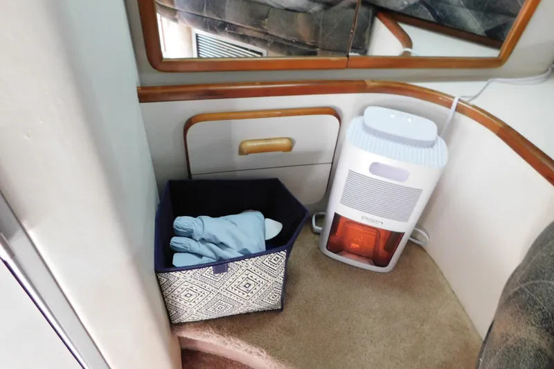 Slide: The Image of Interior of 1990 Sea Ray 350 Express Cruiser with heater and storage basket. - 36