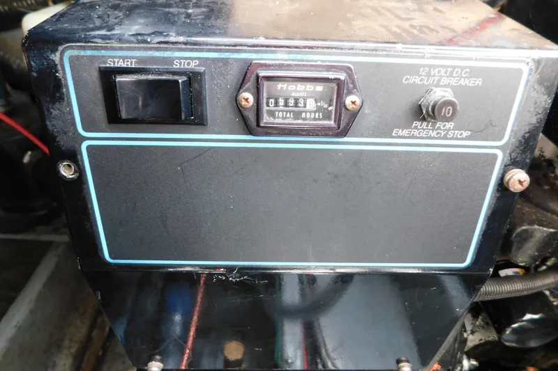 Slide: The Image of Control panel of a 1990 Sea Ray 350 Express Cruiser with hour meter and emergency stop. - 76
