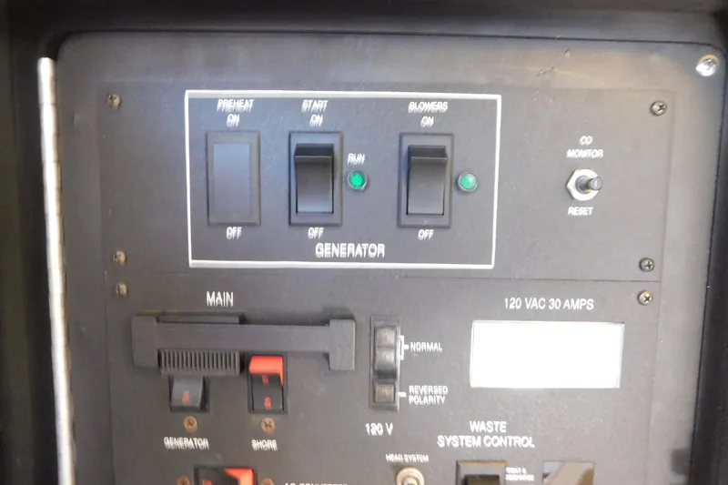 Slide: The Image of Control panel of a 1990 Sea Ray 350 Express Cruiser, featuring generator and system controls. - 61