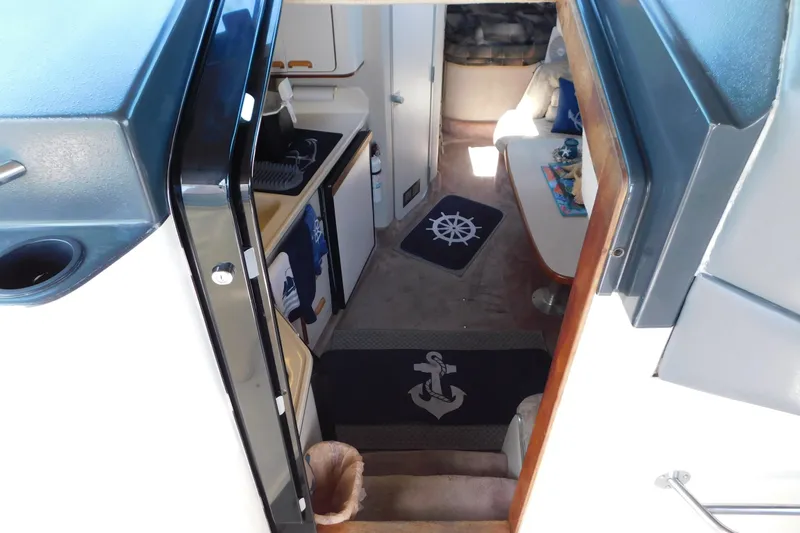 Slide: The Image of Interior view of 1990 Sea Ray 350 Express Cruiser, featuring cozy cabin and nautical decor. - 24