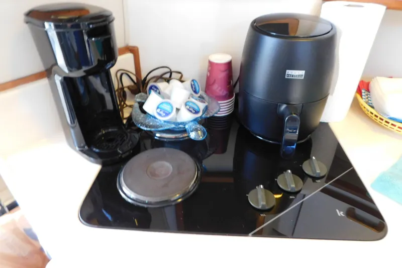 Slide: The Image of Kitchen appliances on a 1990 Sea Ray 350 Express Cruiser, including coffee maker and air fryer. - 58