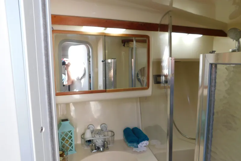 Slide: The Image of Bathroom interior of 1990 Sea Ray 350 Express Cruiser with mirror and shower. - 45