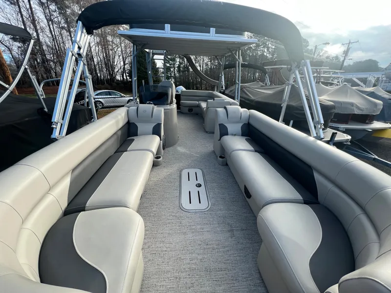 Slide: The Image of Interior view of a spacious pontoon boat with cushioned seating and a sunshade. - 5