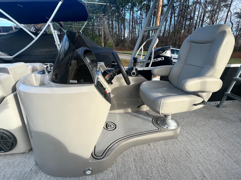 Slide: The Image of Helm of a Premier 240 SunSpree Water Slide boat with beige seat and steering wheel. - 8