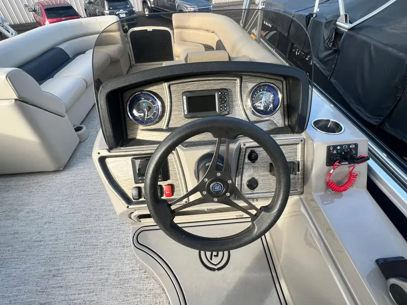 Slide: The Image of The image shows the helm of a 2020 Premier 240 SunSpree Water Slide boat. - 9