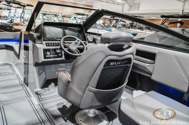 Slide: The Image of 2026 Cobalt R4 Surf boat interior with modern dashboard and steering wheel at Lake Norman Marina. - 13