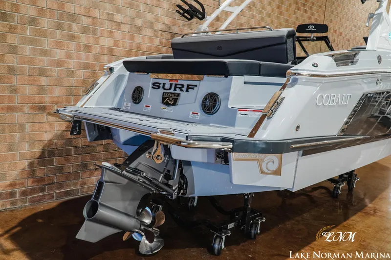 Slide: The Image of 2026 Cobalt R4 Surf boat at Lake Norman Marina, showcasing sleek design and powerful engine. - 5