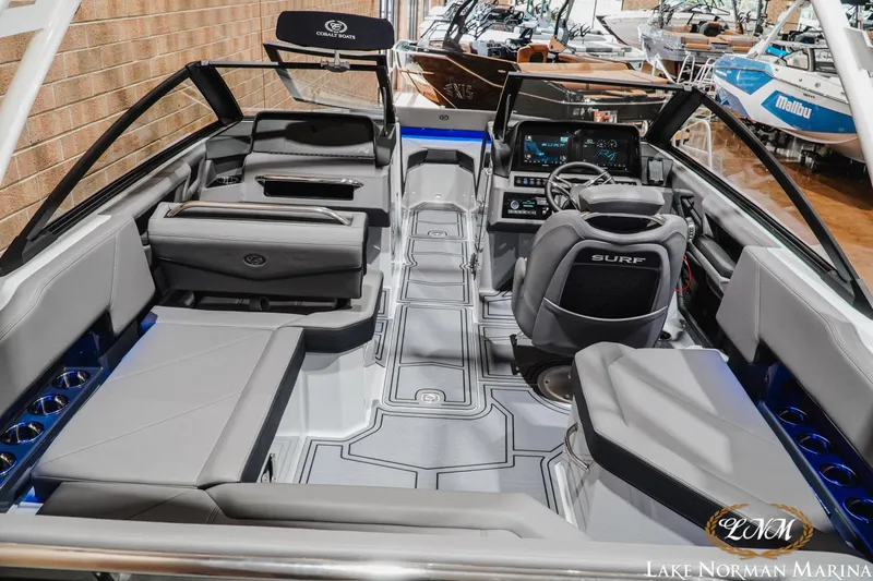 Slide: The Image of 2026 Cobalt R4 Surf boat interior with modern dashboard and seating at Lake Norman Marina. - 11