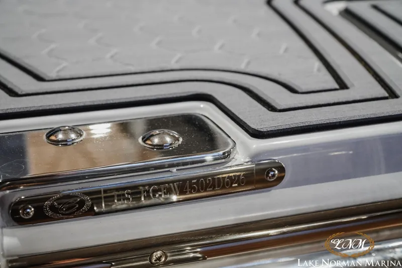 Slide: The Image of 2026 Cobalt R4 Surf boat detail with metal and textured surface at Lake Norman Marina. - 26