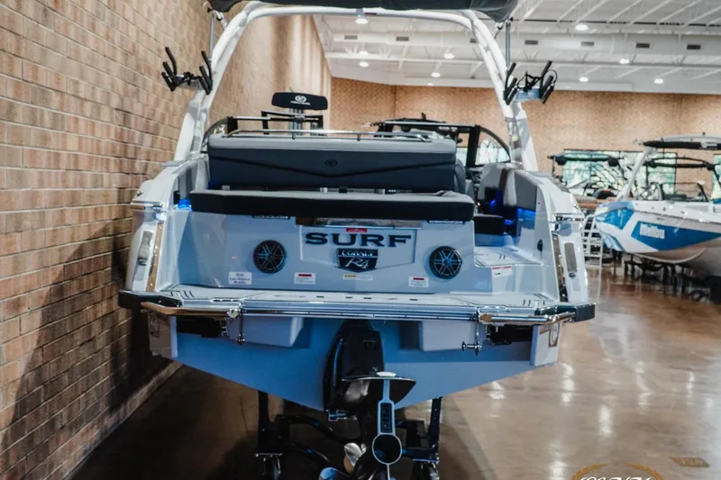 Slide: The Image of 2026 Cobalt R4 Surf boat displayed indoors, showcasing rear design and features. - 6